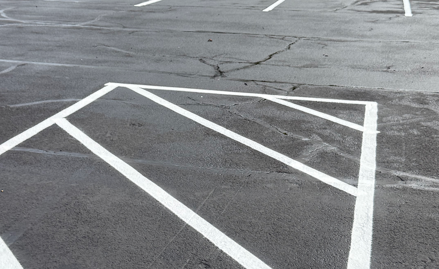 Freshly painted parking lines on an asphalt surface